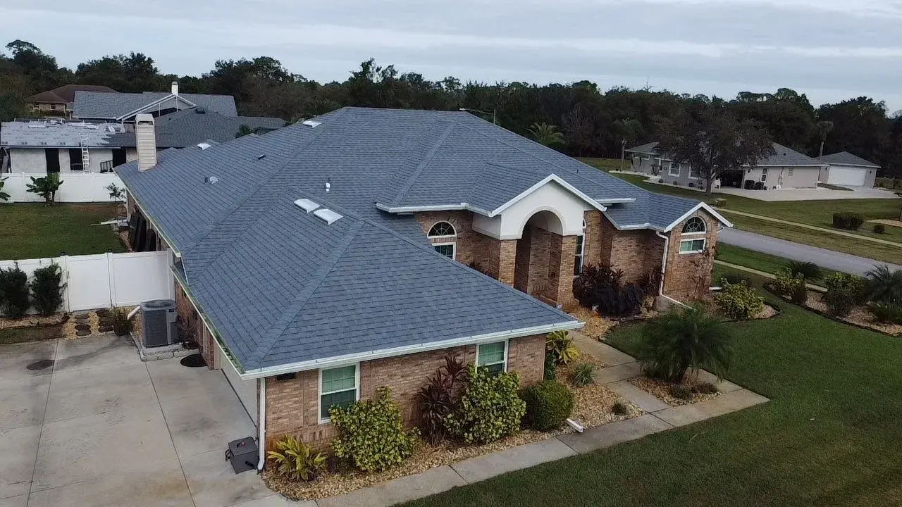 Gray shingle roof on a brick home photographed from above